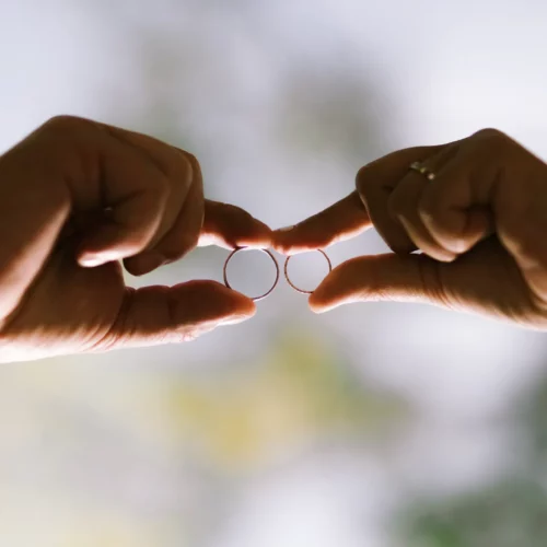 Mains des mariés tenant leurs alliances l'une contre l'autre - Photographe mariage Beuvron-en-Auge