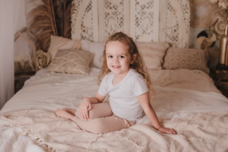 Portrait d'une petite fille pétillante aux cheveux bouclés dans un décor de studio bohème et épuré - Photographe Famille aux alentours de Colombelles Portrait d'une petite fille pétillante aux cheveux bouclés dans un décor de studio bohème et épuré - Photographe Famille aux alentours de Colombelles