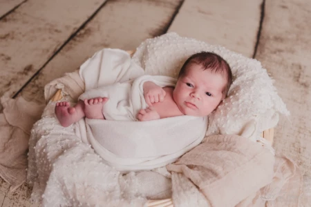 Nouveau-né éveillé délicatement emmailloté dans un panier avec des voilages blancs - Photographe Naissance à Caen Nouveau-né éveillé délicatement emmailloté dans un panier avec des voilages blancs - Photographe Naissance à Caen