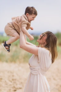 Maman souriante soulevant son petit garçon dans les airs sur la plage - Photographe enfant Deauville Maman souriante soulevant son petit garçon dans les airs sur la plage - Photographe enfant Deauville